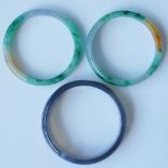 Two jadeite bangles of plain form, bright green, mustard yellow, 6.