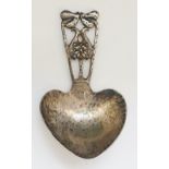 A silver Arts and Crafts caddy spoon, the handle in the from of stylised leaves and flowers,