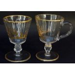 A near pair of punch cups, the slice cut bowls with gilded pastoral scenes,