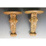 A pair of carved softwood wall brackets,