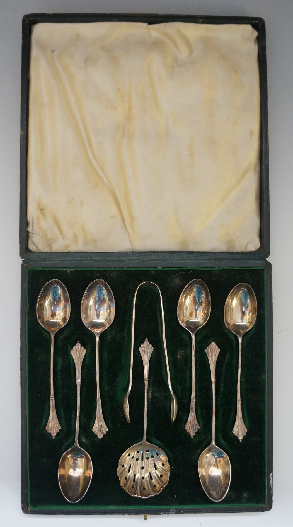 A cased set of six teaspoons, tongs and a sugar sifter,