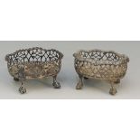 A pair of silver coloured metal salts, pierced bodies with gently ruffled rims, claw and ball feet,