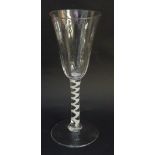 A tall Georgian ale glass with rounded trumpet form bowl, the lower half lightly fluted,