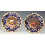 A fine pair of Coalport still life painted shaped circular cabinet plates,