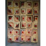 An early to mid 20th Century log cabin patchwork quilt made up of ten by nine multi coloured