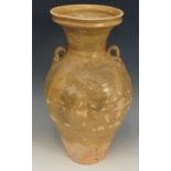 A Chinese Tang dynasty olive green glazed pale terracotta two handled vasular jar with spreading