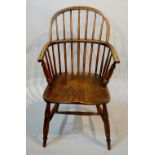 A 19th Century ash and elm Windsor elbow chair with saddle seat on turned supports joined by an H