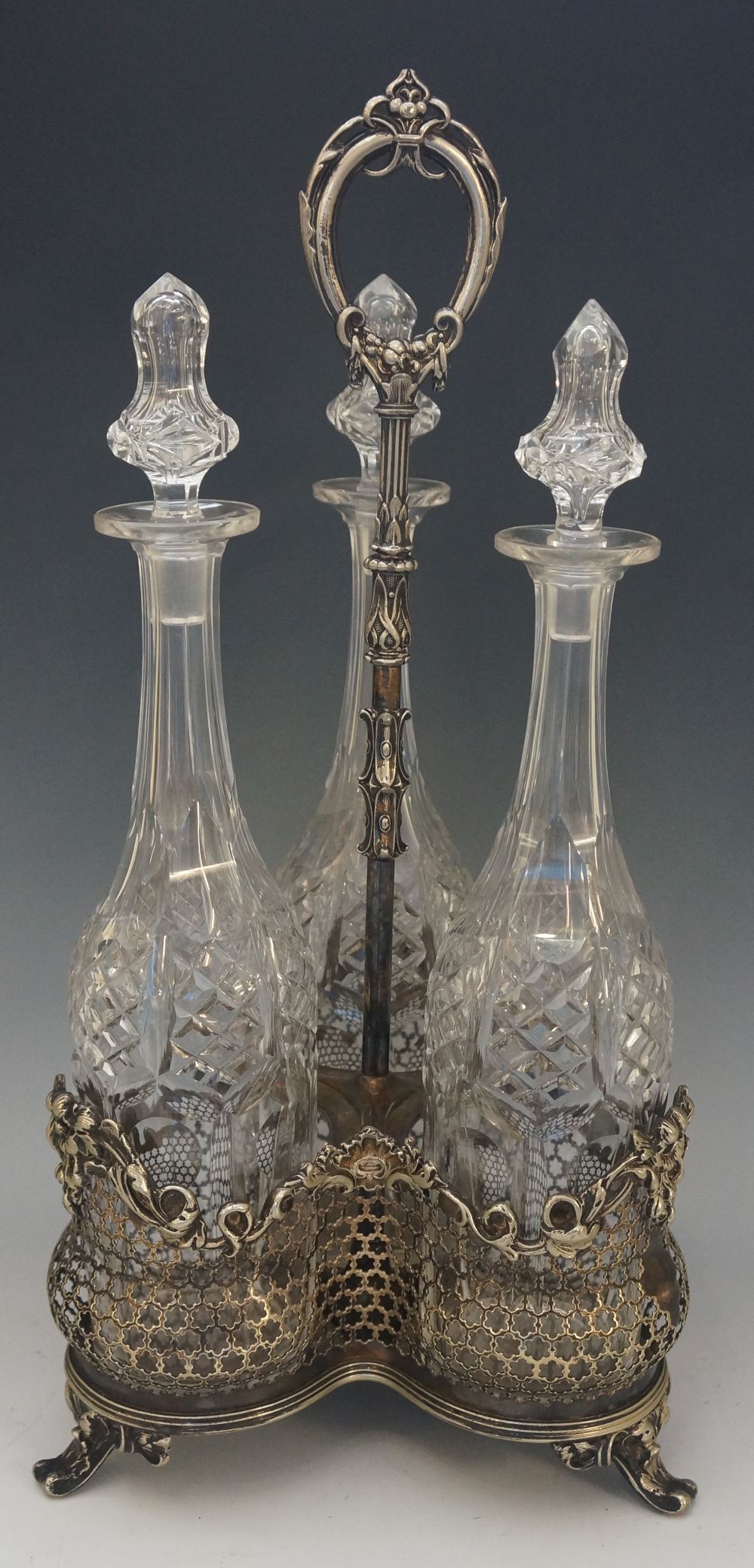 A Victorian silver plated trefoil decanter stand with three matching spirit decanters, all diamond,