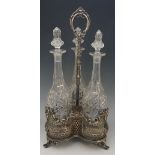 A Victorian silver plated trefoil decanter stand with three matching spirit decanters, all diamond,