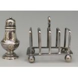 A miniature silver toast rack of simple angular form with plain ball feet,