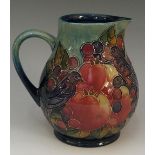 A Moorcroft finch and berry pattern jug, tube lined with birds amidst pomegranates,
