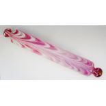 A 19th Century Nailsea pink and white glass rolling pin,