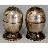 A pair of early 20th Century Chinese silver pepperettes, pellet form bodies,