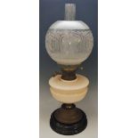 A Victorian oil lamp with pink glass reservoir and acid etched frosted globular shade,