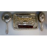 A silver dressing table set comprising: a hair brush, clothes brush and hand mirror,