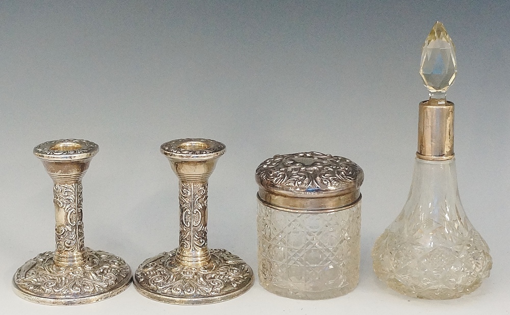 A selection of silver items to include: a pair of candlesticks,