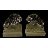 A pair of Art Deco Czech clear and frosted glass bookends, moulded as rearing rams,