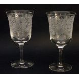 A pair of 20th Century Stuart glass wine goblets, engraved with hounds and stags,