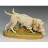 A Royal Dux model of a pair of hounds wearing green collars on an oval rustic base, 28cm wide max.