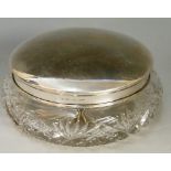 A plain silver topped dressing table jar with cut glass body, star cut base,