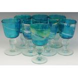 A set of eight Mdina glass goblets, lustred turquoise bowls with irregular yellow/gold swirls,