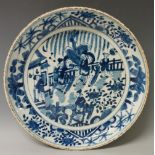 An 18th Century blue and white circular dish painted to the centre with figures on horseback and