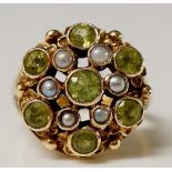 A Victorian 9ct gold peridot and seed pearl ring the circular setting set central peridot flanked