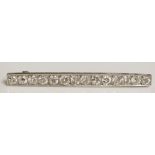 An Edwardian white gold diamond set bar brooch set fourteen evenly sized brilliants, 4.