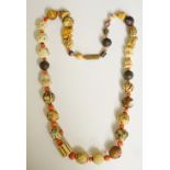 A good Japanese ivory, coral, boxwood ceramic and cloisonné enamel necklace,