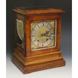 A Victorian walnut cased mantel clock in George II style the top with bevelled glazed panel,