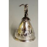 A cast silver table bell, the handle possibly depicting St George killing the dragon,