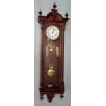 A reproduction mahogany cased Vienna wall clock of conventional form with ball and spire finials