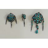 A Victorian silver enamel turquoise and seed pearl brooch of scroll form set oval and round collet