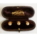 A set of three cased 9ct gold foliate engraved dress studs the box inscribed George E Butcher,