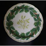 A Copeland shaped circular Christmas plate printed and painted to the centre with mistletoe within