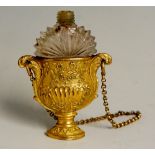 A 19th Century gilt metal and cut glass scent bottle the gilt metal urnular shaped case with pair