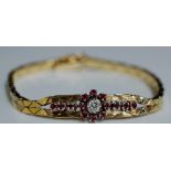 An Edwardian 9ct gold ruby and diamond bracelet the flattened articulated link bracelet centred on