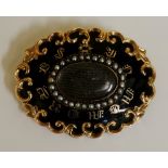 A Victorian 9ct gold mourning brooch the oval centre vacant within a seed pearl frame,