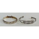 A sterling silver foliate engraved bangle with safety chain, a silver bangle,