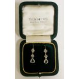 A pair of diamond set ear pendants the rough cut triangular shaped brilliants below pairs of