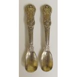 A pair of silver Kings pattern mustard spoons, the handles with unresearched crests,