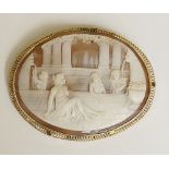 A late Victorian oval shell cameo carved with semi clad bathers in a bathing house with pillars and