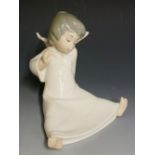 A Lladro figure of a seated winged young female angel, 15cm high, printed mark in blue,