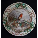 A Copeland circular Christmas plate transfer printed and painted to the centre with a Robin on a