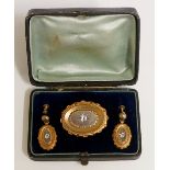 A late 19th Century pinchbeck demi-parure comprising shaped oval brooch gypsy set to the centre