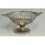 A silver bon bon dish with pierced sides, the two handle in the form of wreaths and ribbons,