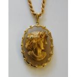 A 9ct gold oval pendant, head and shoulder bust of a young woman her hair set diamond chips,