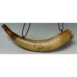 An engraved cow horn powder flask the body engraved GR the top engraved belt and buckle,