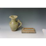 A Chinese Celadon glazed pottery jug with moulded serpent handle, the neck with triple band,