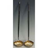 A pair of Georgian style punch ladles, baleen twist carved stem handles,